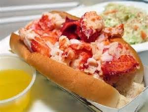 A lobster roll in a bun is served with melted butter and a side of coleslaw at James Place Inn News.