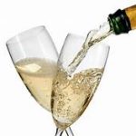 Champagne is being poured into two glasses, perfect for a February romantic bed and breakfast getaway.