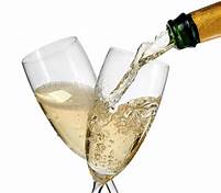 Champagne is being poured into two glasses, perfect for a February romantic bed and breakfast getaway.